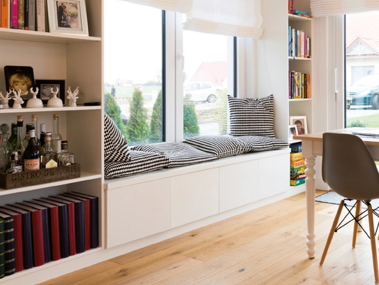 Haus Quistorp – Hier dient die Fensterbank als eine kuschelige Nische für nette Stunden mit der Familie. (Foto: © BAUMEISTER-HAUS)