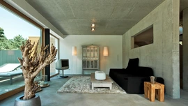Wohnzimmer mit Sichtbetonwänden im Wabi-Sabi-Stil